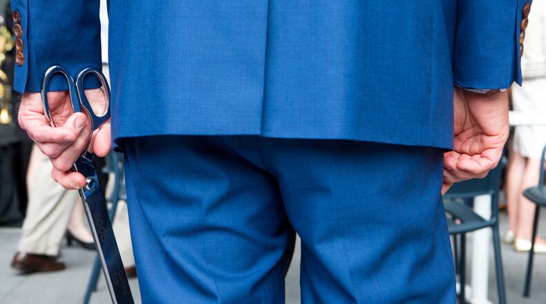 Georgia governor Brian Kemp holds a pair of ribbon cutting scissors shortly after cutting the ribbon at the grand opening of Coda, the latest addition to Technology Square, at 756 West Peachtree Street Northwest in downtown Atlanta, Ga., on Thursday, May 23, 2019. (Casey Sykes for The Atlanta Journal-Constitution)