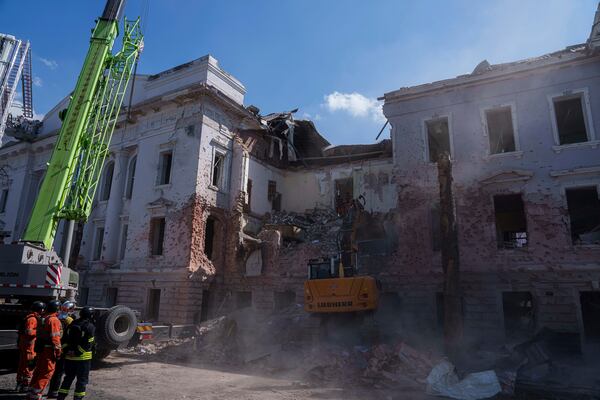 An excavator clears the rubble from a University building destroyed by a Russian missile strike in Sumy, Ukraine, Monday, April 14, 2025. (AP Photo/Evgeniy Maloletka)