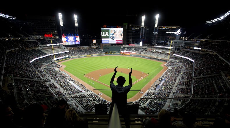 Usher Melvin Russ dances in the aisle during the sixth inning of an exhibition spring training baseball game between the Atlanta Braves and the New York Yankees at the Brave’s new stadium, SunTrust Park, in Atlanta, Friday, March 31, 2017. (AP Photo/David Goldman)
