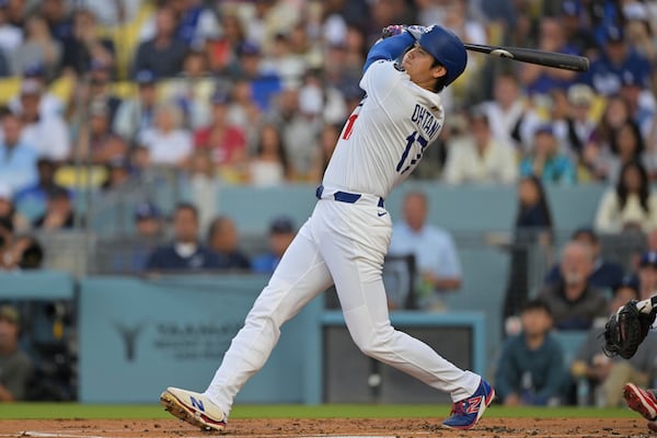 Los Angeles Dodgers' Shohei Ohtani hits a two-run home run during the first inning of a baseball game against the Minnesota Twins in Los Angeles, Monday, July 21, 2025. (AP Photo/Jayne Kamin-Oncea)