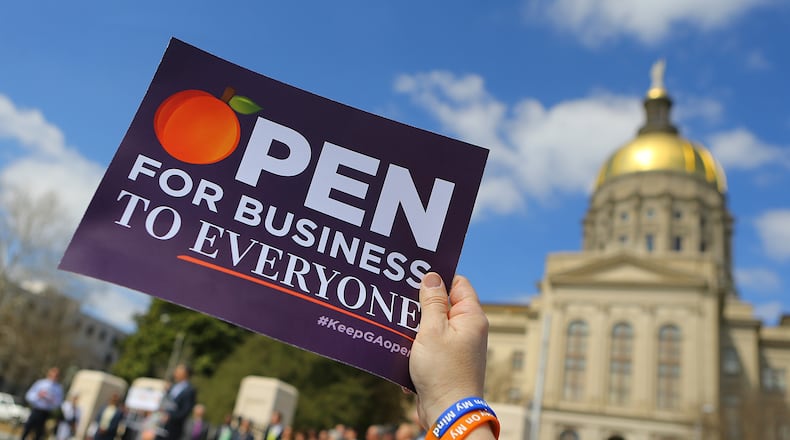 031715 ATLANTA: Audrey "Mayour" Martin holds a sign in the air during a rally at the Capitol against SB 129, the "license to discriminate" legislation pushed by Sen. Josh McKoon and Rep. Sam Teasley on Tuesday, March 17, 2015, at Liberty Plaza in Atlanta. Curtis Compton / ccompton@ajc.com Audrey "Mayour" Martin holds a sign in the air during a Tuesday rally at the Capitol against SB 129, “religious liberty” legislation authored by state Sen. Josh McKoon, R-Columbus. Opponents argue that it would give protection to those who would discriminate against gay couples. Curtis Compton/ccompton@ajc.com