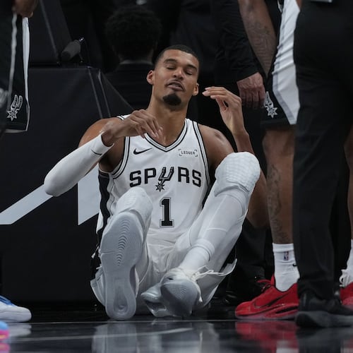 San Antonio Spurs forward Victor Wembanyama (1) sits on the court after a hard fall during the first half in Game 2 of a first-round NBA playoffs basketball series against the Portland Trail Blazers in San Antonio, Tuesday, April 21, 2026. (AP Photo/Eric Gay)
