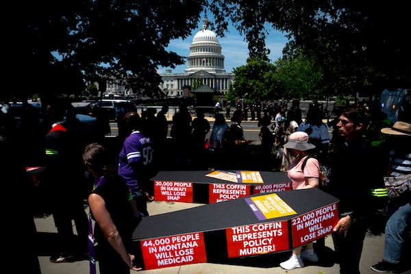 Demonstrators carry cardboard caskets in front of the U.S. Capitol in protest of President Donald Trump's tax breaks and spending cuts package, Monday, June 30, 2025, in Washington. (AP Photo/Julia Demaree Nikhinson)