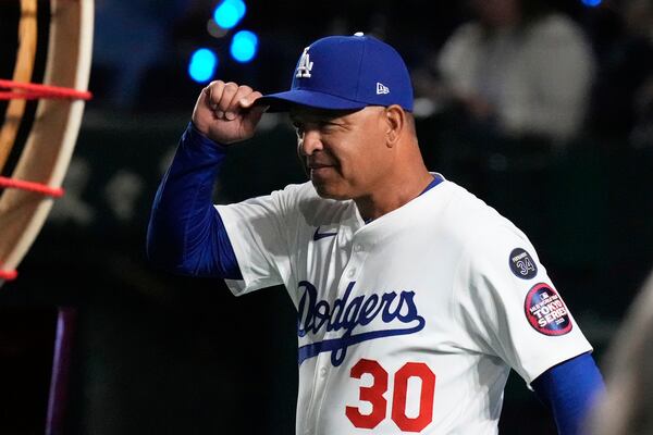 Los Angeles Dodgers manager Dave Roberts walks on to the field during team introductions before an MLB Tokyo Series baseball game against the Chicago Cubs in Tokyo, Japan, Wednesday, March 19, 2025. (AP Photo/Eugene Hoshiko)