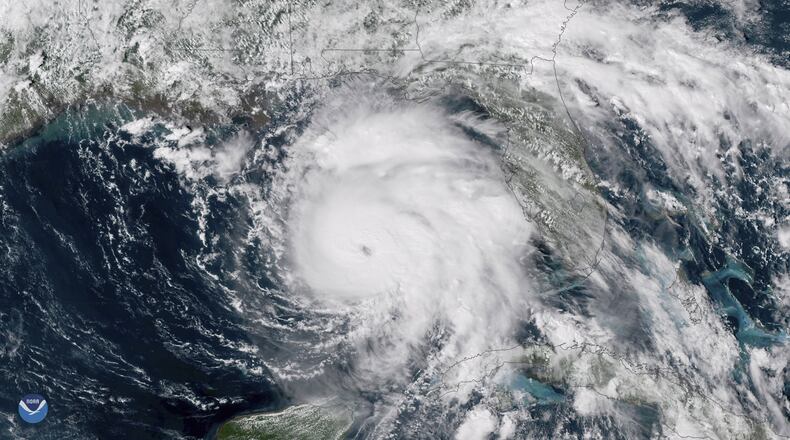 This Tuesday, Oct. 9, 2018 satellite image provided by NOAA shows Hurricane Michael, center, in the Gulf of Mexico. (NOAA via AP)