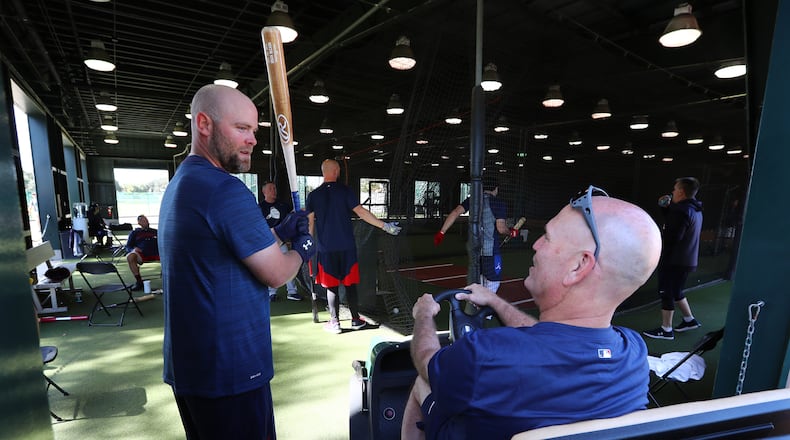 Brian chats with Brian: Manager Brian Snitker relaxes while chatting with catcher Brian McCann during spring training Friday. (Curtis Compton/ccompton@ajc.com)