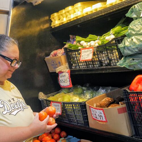 Ada Torres holds tomatoes while shopping for produce, Thursday, July 2, 2026, in Cleveland, Texas, about 45 miles northeast of Houston. (Sandy Guatibonza/La Esquina TX via AP)