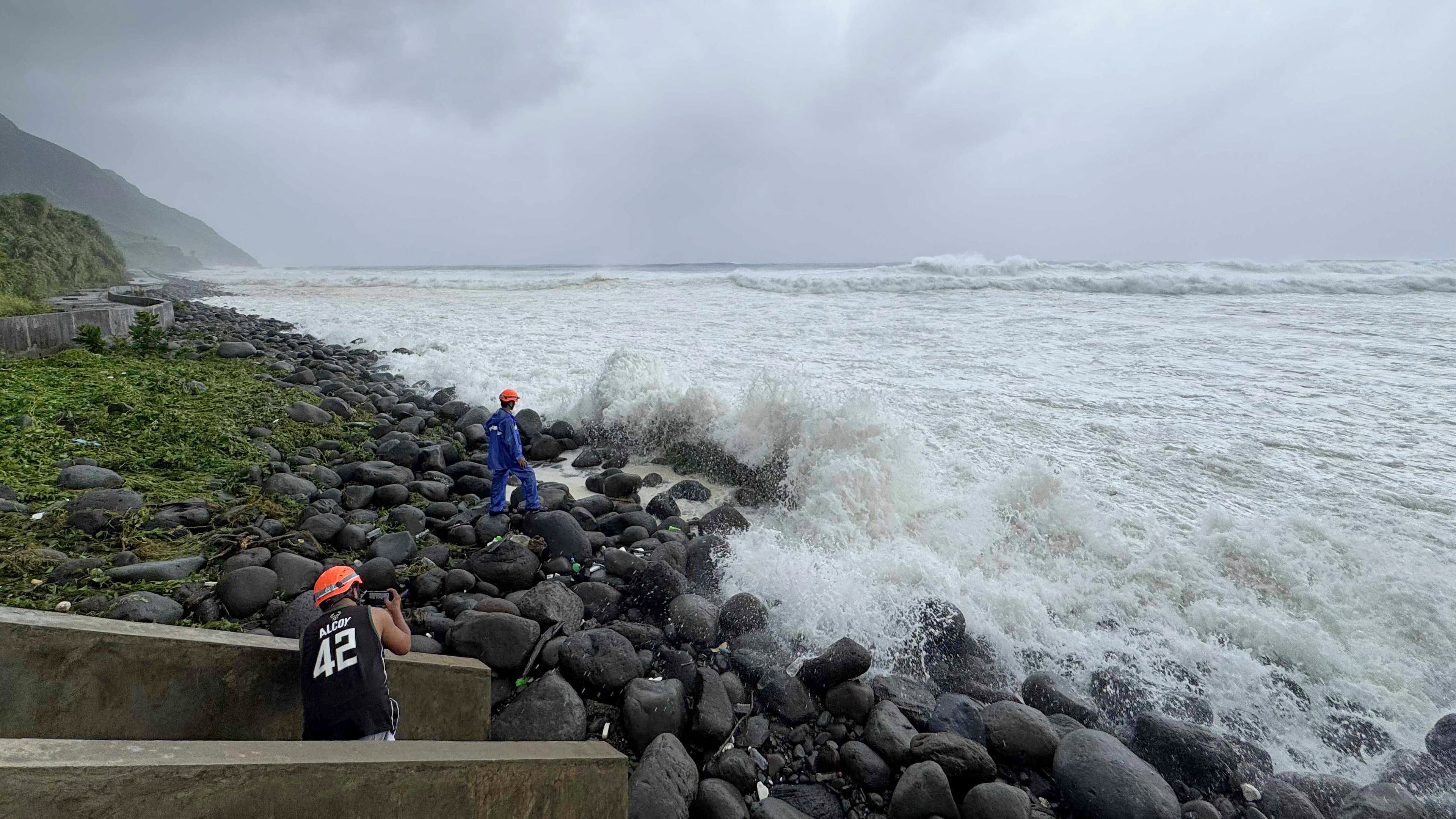 People watch as strong waves batter Basco, Batanes province, northern Philippines as Typhoon Ragasa affects the area on Monday, Sept. 22, 2025. (AP Photo/Justine Mark Pillie Fajardo)