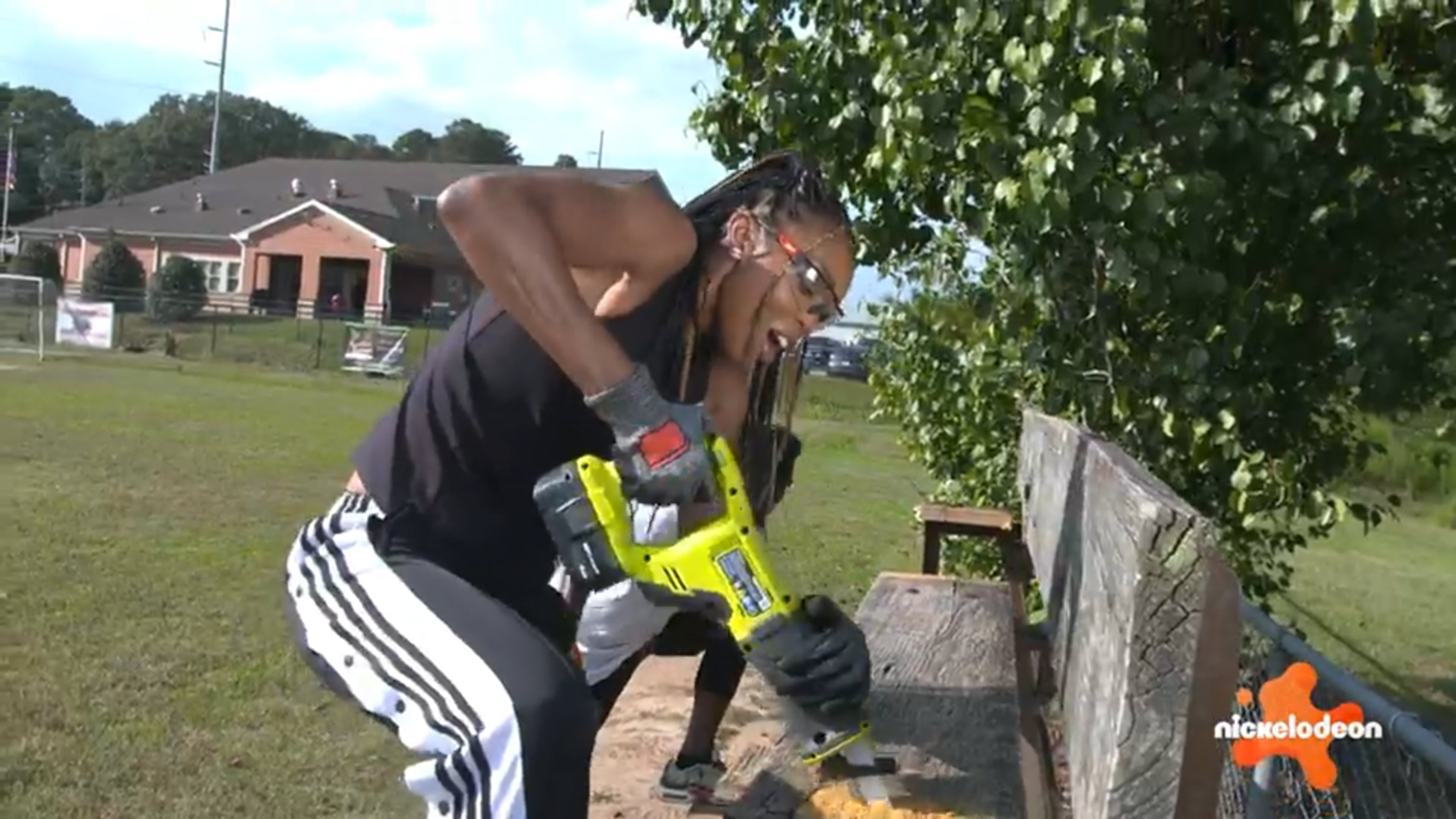 Renee Montgomery dismantles an aging bleacher at Sporting Club Stockbridge Soccer Academy, which was renovated for a new Nickelodeon show “Play It Forward.“ (Nickelodeon)