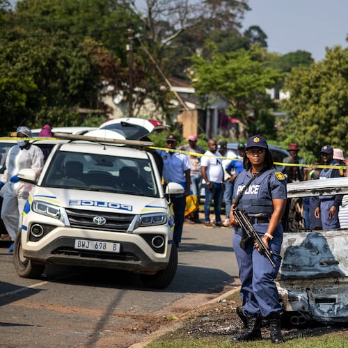 A police officer stands at the scene of a mass shooting at a house party in KwaMakhutha township south of the city of Durban, South Africa, Wednesday, Sept. 23, 2026. (AP Photo)