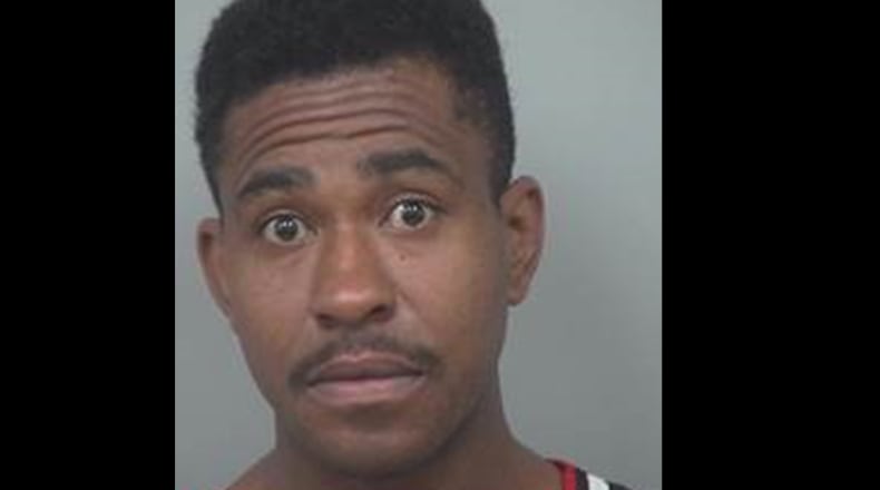 Charles "Carlos" Bacote has been arrested on a charge of aggravated assault and is a person of interest in a January homicide.