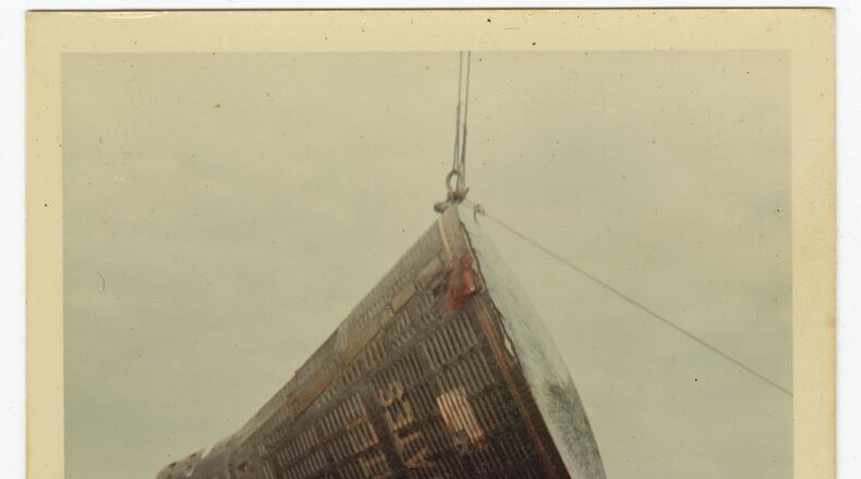 This 1966 image taken by Ron McQueeney shows the Gemini 8 spacecraft being lifted for transport at Naha Air Base in Okinawa, Japan. (Ron McQueeney/Ohio History Connection via AP)