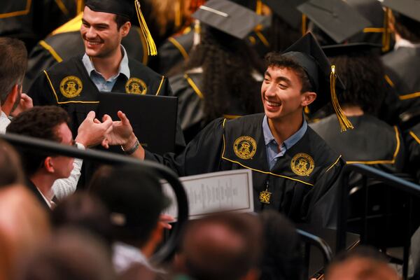 Kennesaw State students celebrate with friends and family members after receiving their diplomas during the Spring 2025 commencement on Tuesday, May 6, 2025, in Kennesaw. (Jason Getz/AJC)