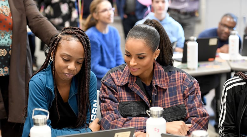 Cedreice Allen, a ninth grade student at Paul Duke STEM High School shows R&B singer-songwriter Ciara how she used digital technology to re-mix her song “SET” the artist’s latest album. (Photo by Paras Griffin/Getty Images for Amazon)