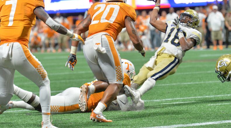 Georgia Tech quarterback TaQuon Marshall (16) attempts to make a pitch on the final play of Monday's Chick-fil-A Kickoff game at Mercedes-Benz Stadium. Tennessee stopped the Jackets on the play to preserve the 42-41 double overtime victory. Hyosub Shin/hshin@ajc.com