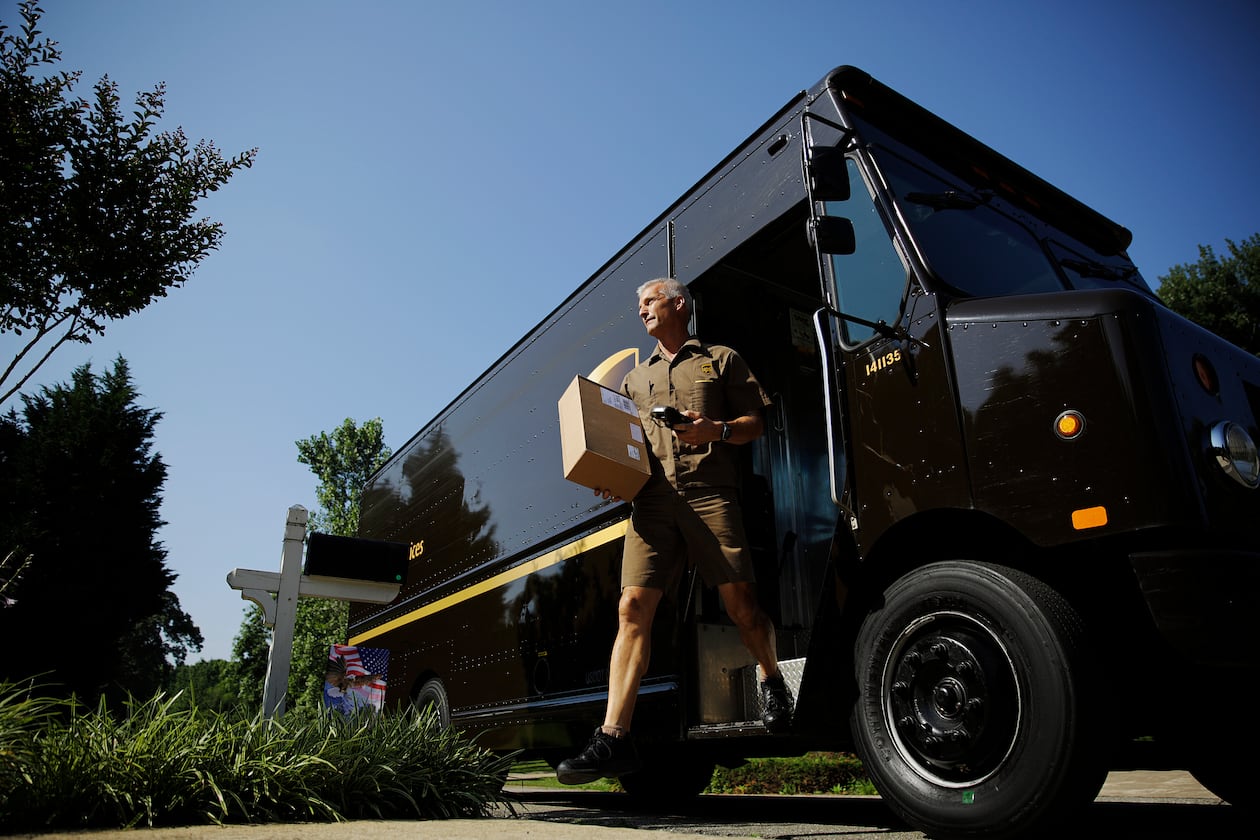 UPS driver Marty Thompson delivers a package in Cumming. DeKalb has granted the company a tax break to try to keep its Pleasantdale Road facility open. (AP 2014)