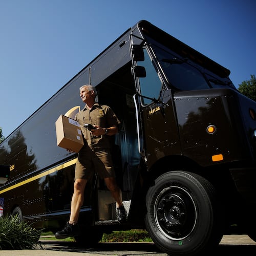 UPS driver Marty Thompson delivers a package in Cumming. DeKalb has granted the company a tax break to try to keep its Pleasantdale Road facility open. (AP 2014)