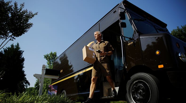 UPS driver Marty Thompson delivers a package in Cumming. DeKalb has granted the company a tax break to try to keep its Pleasantdale Road facility open. (AP 2014)