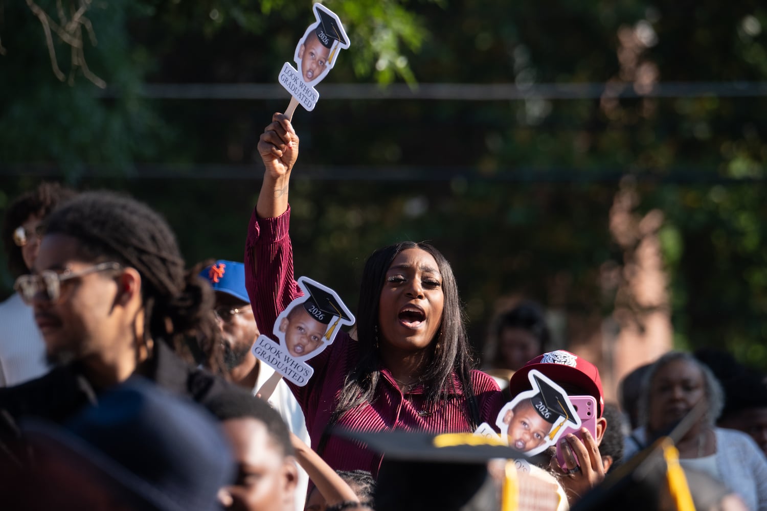 A person reacts as students walk in the procession before the Morehouse College graduation Sunday, May 17, 2026. (Ben Gray for the AJC)
