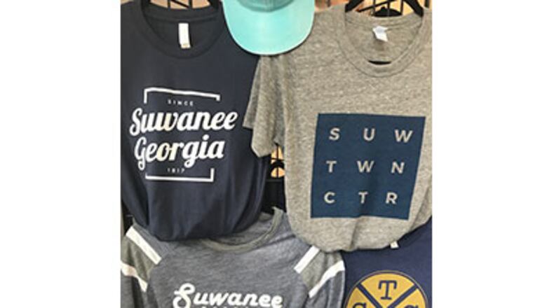 Merchandise like these t-shirts is sold in the Suwanee Welcome Center operated by the North Gwinnett Arts Association in conjunction with the city. Suwanee and the NGAA recently updated how proceeds from sales will be shared. Courtesy City of Suwanee