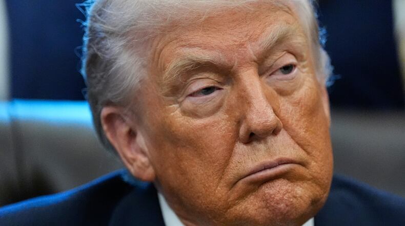 President Donald Trump listens in the Oval Office of the White House, Wednesday, Jan. 14, 2026, in Washington. (AP Photo/Alex Brandon)