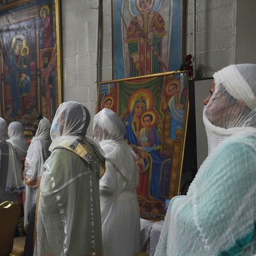 FILE - Congregants wear netela, a white scarf-like cotton cloth that signifies modesty and purity, during a service at Re'ese Adbarat Debre Selam Kidist Mariam Church, an Ethiopian Orthodox Tewahedo church, in Washington, on Saturday, April 5, 2025. (AP Photo/Jessie Wardarski, File)