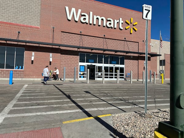 FILE -Shoppers outside a Walmart store, Feb. 7, 2025, in Englewood, Colo. (AP Photo/David Zalubowski), File)