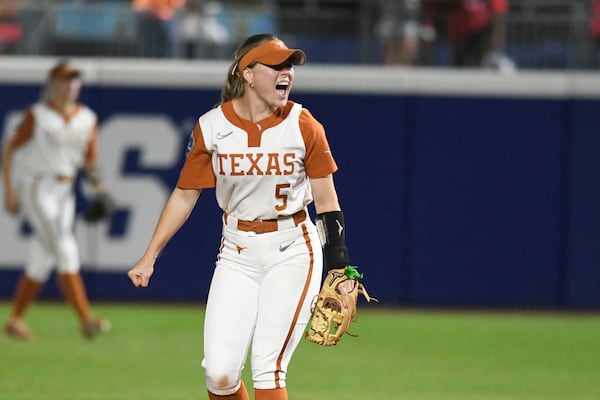 Texas utility player Kaydee Bennett celebrates during the first game of the NCAA softball Women's College World Series finals against Texas Tech in Oklahoma City, Wednesday, June 4, 2025. (AP Photo/Kyle Phillips)