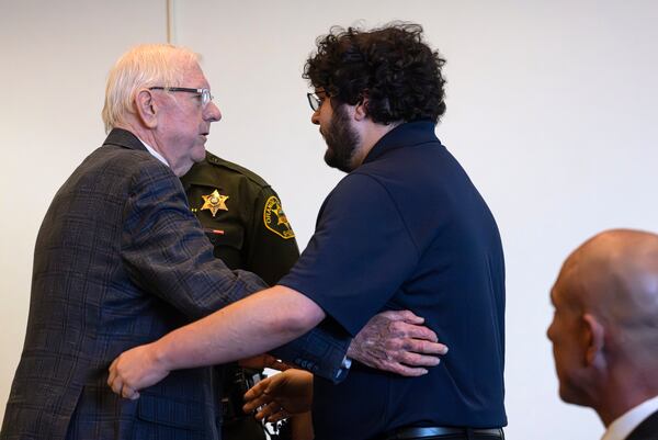 An Orange County Superior Court jury found Orange County Superior Judge Jeffrey Ferguson, left, guilty of second-degree murder in the 2023 shooting death of his wife Sheryl Ferguson, and after he embraced his son, Phillip Ferguson, before being led away in handcuffs Tuesday, April 22, 2025, in Santa Ana, Calif. (Mindy Schauer/The Orange County Register via AP, Pool)