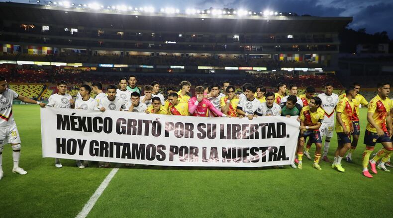 Players of Atletico Morelia and Leones Negros hold a sign that reads, "Mexico shouted for its freedom. Today, we shout for ours," before a Mexican second-division soccer match in Morelia, Michoacan state, Mexico, Saturday, Sept. 19, 2026. (AP Photo/Armando Solis)