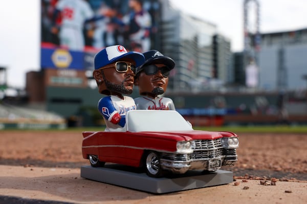 The OutKast bobblehead, featuring duo Big Boi and Andre 3000, is shown on the field before the Atlanta Braves host the Milwaukee Brewers at Truist Park in Atlanta. (Jason Getz/AJC 2024)
