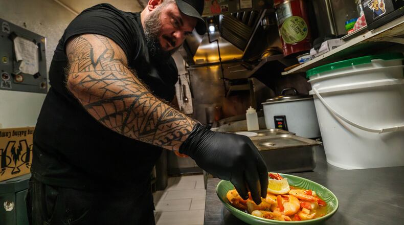 Sea Wolf head chef Justin Waldman prepares a dish with fresh local shrimp at his restaurant on Tybee Island, Ga., Friday, Aug. 14, 2026. (Justin Taylor/The Current GA/CatchLight/Report for America via AP)