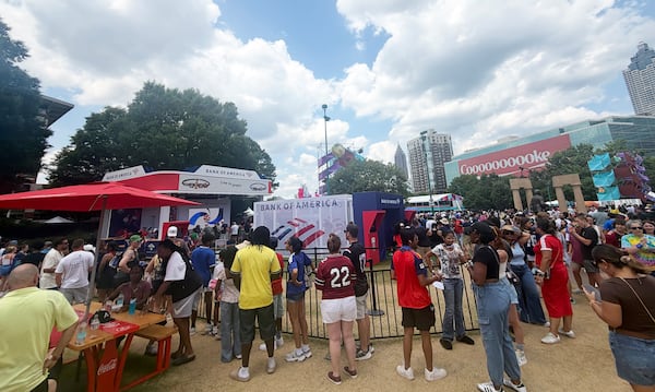 Fans wait outside a booth at Centennial Olympic Park to make a custom bracelet to commemorate the World Cup. (Andre Butso/AJC)