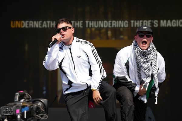 Naoise O Caireallain, left, and Liam Og of the hip hop trio Kneecap perform during the Glastonbury Festival in Worthy Farm, Somerset, England, Saturday, June 28, 2025. (Scott A Garfitt/Invision/AP)