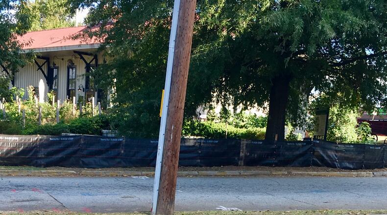 This is all that remains of the Decatur magnolia, a longtime gathering/climbing destination that was about a half century old. The tree, and the triangle that enclosed it, is making way for railroad crossing improvements and the raising and smoothing out of North Candler Road and East Trinity Place. Photo by Bill Banks for the AJC