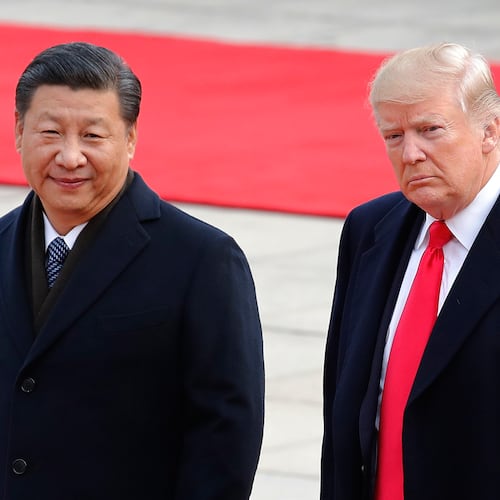 FILE - President Donald Trump, right, walks with Chinese President Xi Jinping during a welcome ceremony at the Great Hall of the people in Beijing, Nov. 9, 2017. (AP Photo/Andy Wong, File)
