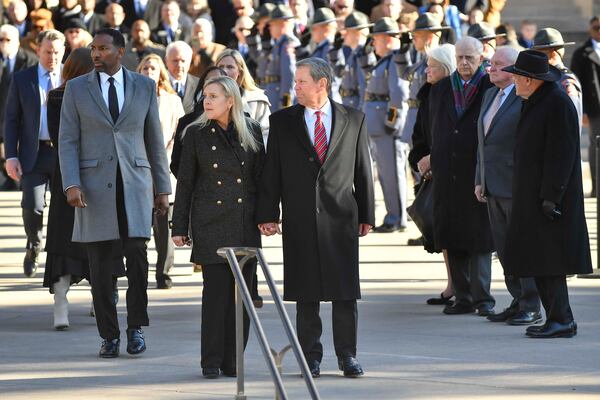 Atlanta Mayor Andre Dickens (left), Georgia First Lady Marty Kemp, her husband, Gov. Brian Kemp, and former governors Roy Barns, Sonny Purdue, and Nathan Deal are seen during a ceremonial pause at the Georgia State Capitol building in downtown Atlanta on Saturday, Jan. 4, 2025. (Daniel Varnado/For the AJC)