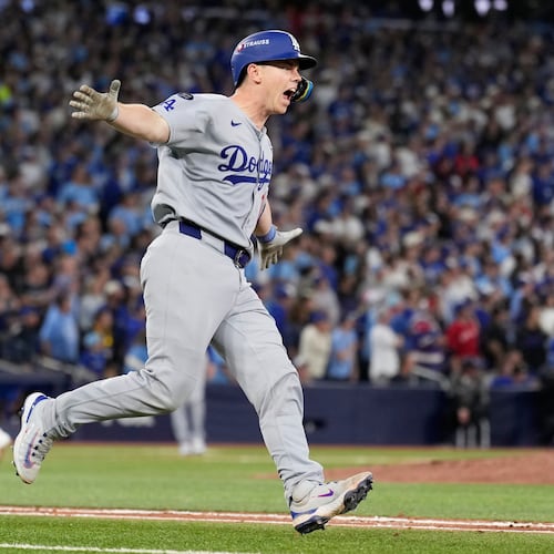 Los Angeles Dodgers' Will Smith celebrates a home run against the Toronto Blue Jays during the11th inning in Game 7 of baseball's World Series, Sunday, Nov. 2, 2025, in Toronto. (AP Photo/Brynn Anderson)