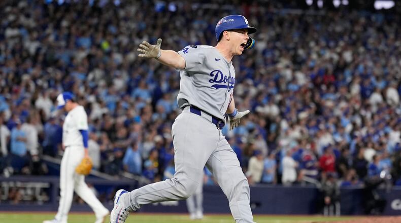 Los Angeles Dodgers' Will Smith celebrates a home run against the Toronto Blue Jays during the11th inning in Game 7 of baseball's World Series, Sunday, Nov. 2, 2025, in Toronto. (AP Photo/Brynn Anderson)