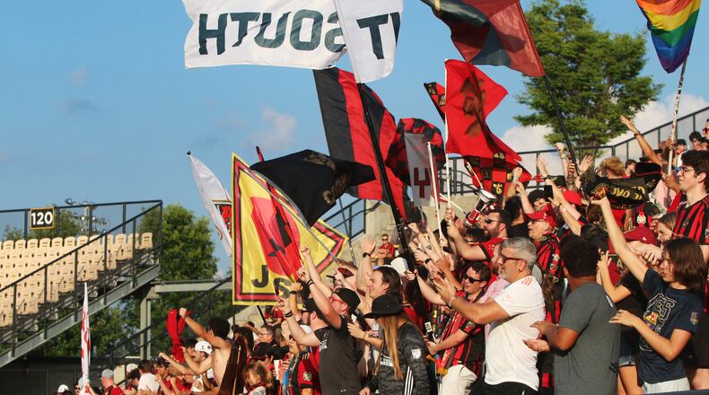 Atlanta United fans wave flags and cheer during a match between Atlanta United and Saint Louis FC at Kennesaw State University in Kennesaw, Georgia on Wednesday, July 10, 2019. Atlanta United defeated Saint Louis FC 2-0. Christina Matacotta/Christina.Matacotta@ajc.com