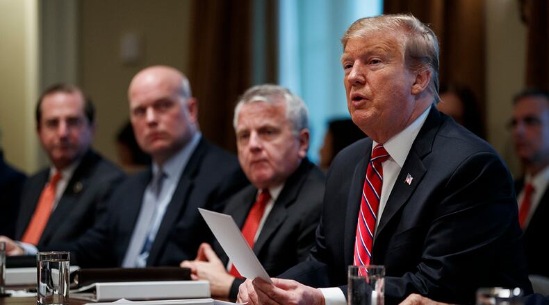 President Donald Trump speaks during a cabinet meeting at the White House, Tuesday, Feb. 12, 2019, in Washington. From left, Secretary of Health and Human Services Alex Azar, acting Attorney General Matthew Whitaker, Deputy Secretary of State John Sullivan, and Trump. (AP Photo/ Evan Vucci)