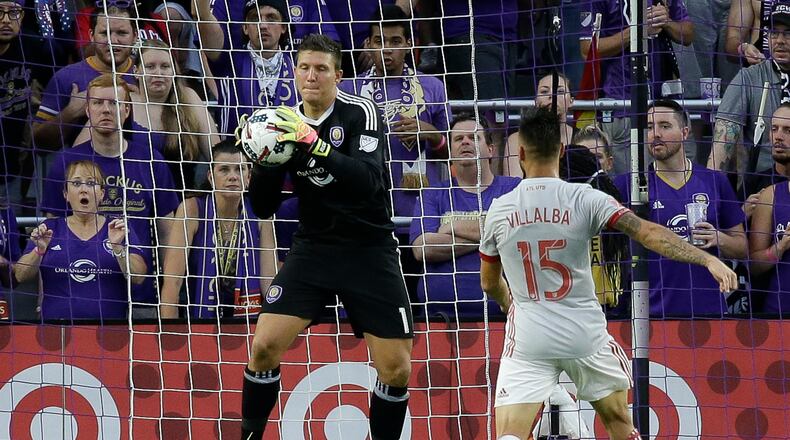 Orlando City goalkeeper Joseph Bendik, left, blocks a shot on goal as Atlanta United's Hector Villalba (15) moves in during the first half of an MLS soccer match, Friday, July 21, 2017, in Orlando, Fla. (AP Photo/John Raoux)