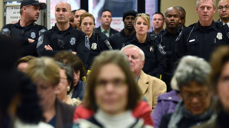 Police officers and other government employees packed the DeKalb County Commission meeting as they urged elected officials to approve pay raises Thursday. HYOSUB SHIN / HSHIN@AJC.COM