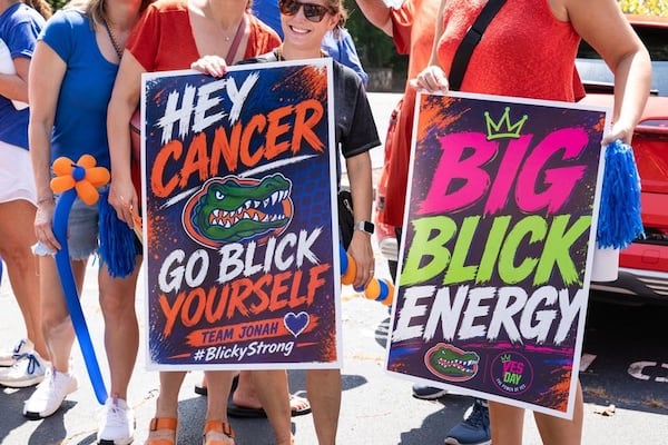 Many of Jonah Blick’s supporters hold signs to support the 14-year-old during a recent event. (Courtesy of Steven Dewberry) 