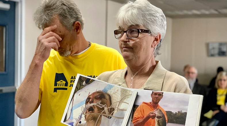 Sandy Ray holds photos of her son, Steven Davis, during a news conference at the Alabama Statehouse in Montgomery. The U.S. Department of Justice announced Thursday that it believes Alabama’s prisons for men are unconstitutional because inmates are subjected to excessive force at the hands of prison staff. (AP Photo/Kim Chandler, file)