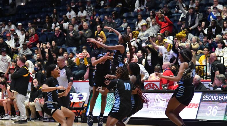 March 11, 2022 Macon - Lovejoy players celebrate their victory over Sequoyah during the 2022 GHSA State Basketball Class AAAAAA Girls Championship game at the Macon Centreplex in Macon on Friday, March 11, 2022. Lovejoy won 54-38 over Sequoyah. (Hyosub Shin / Hyosub.Shin@ajc.com)
