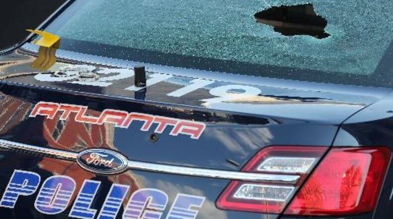 Police car after gunfight Thursday (BEN GRAY/BGRAY@AJC.COM)