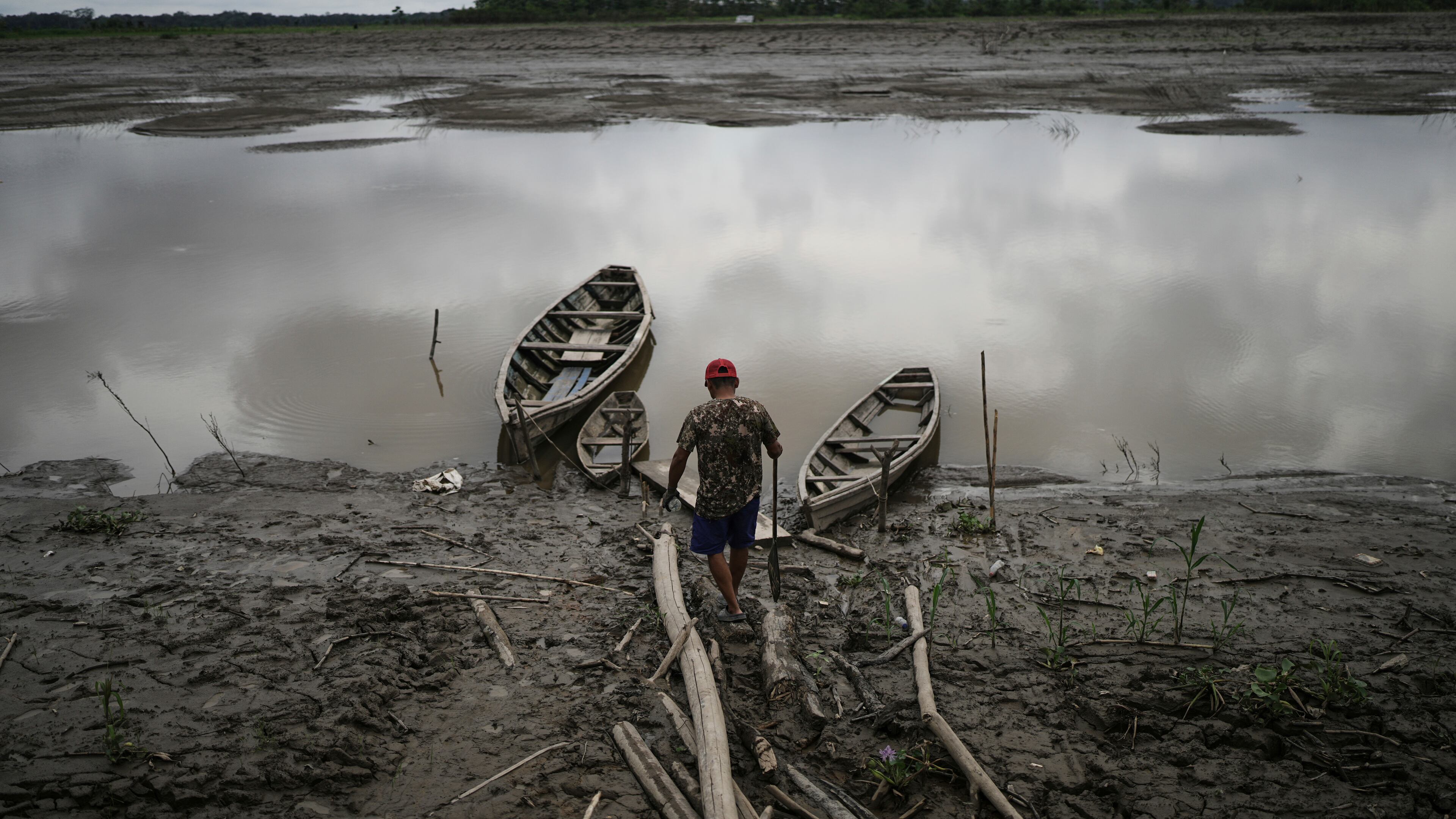 FILE - A fisherman walks to his boat in Santa Rosa, Peru, an island on the Amazon River on Aug. 17, 2025. (AP Photo/Ivan Valencia, File)