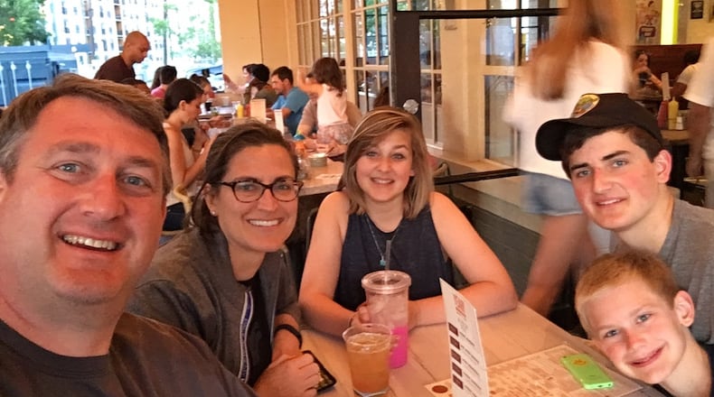 Twenty years later: Gavin Bradley, wife Catherine, and their children Anna Beth (14), Sebastian (16) and Patrick (11). They live in Atlanta. The family of five enjoys watching the Olympics. Their older son likes wearing his parents’ Olympic polo shirts to school. CONTRIBUTED PHOTO