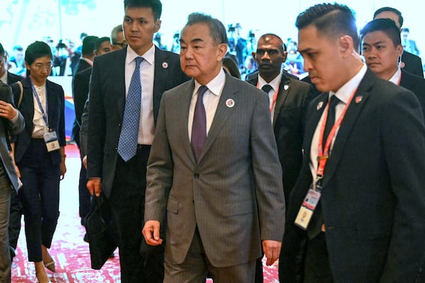 China's Foreign Minister Wang Yi, center, walks on his way to a meeting with U.S. Secretary of State Marco Rubio, unseen, during the 58th ASEAN Foreign Ministers' meeting and related meetings at the Convention Centre in Kuala Lumpur Friday, July 11, 2025. (Mandel Ngan/Pool Photo via AP)